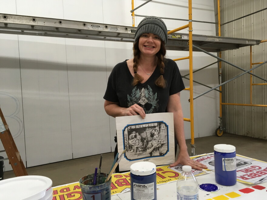 The iconic Clabber Girl Billboard on US-40 just outside of Terre Haute underwent a much-needed restoration in the past year. From WFYIs arts and culture desk, Jill Ditmire spoke with artist Becky Hochhalter about her process as she started the project.