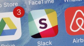 The Slack app is displayed on a mobile phone, Tuesday, Jan. 31, 2017, in New York. Slack Technologies is hoping to convert more big businesses to its online business messaging service by making it easier for workers in different departments to communicate with each other. (Mark Lennihan/AP)
