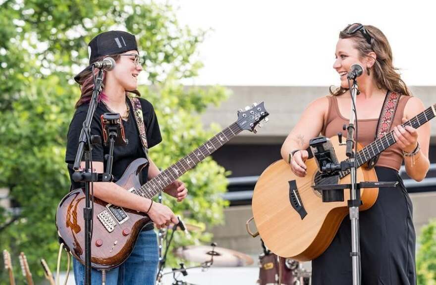 Eva (left) performing with Alex Axup at Bass Street Landing, Moline, in 2024.