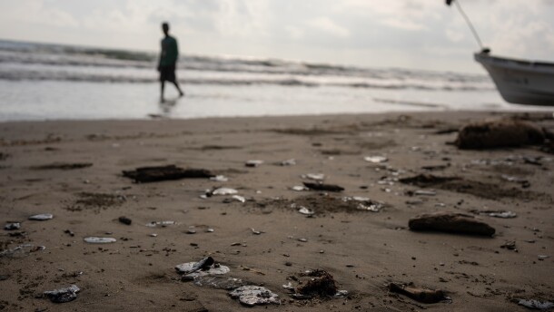 Clumps of oil residue lie on the shore after fishing outings were suspended because of an oil spill that Mexican authorities said originated from an unidentified vessel and two natural oil seeps along the Gulf coast in Salinas, Mexico, Thursday, March 26, 2026.