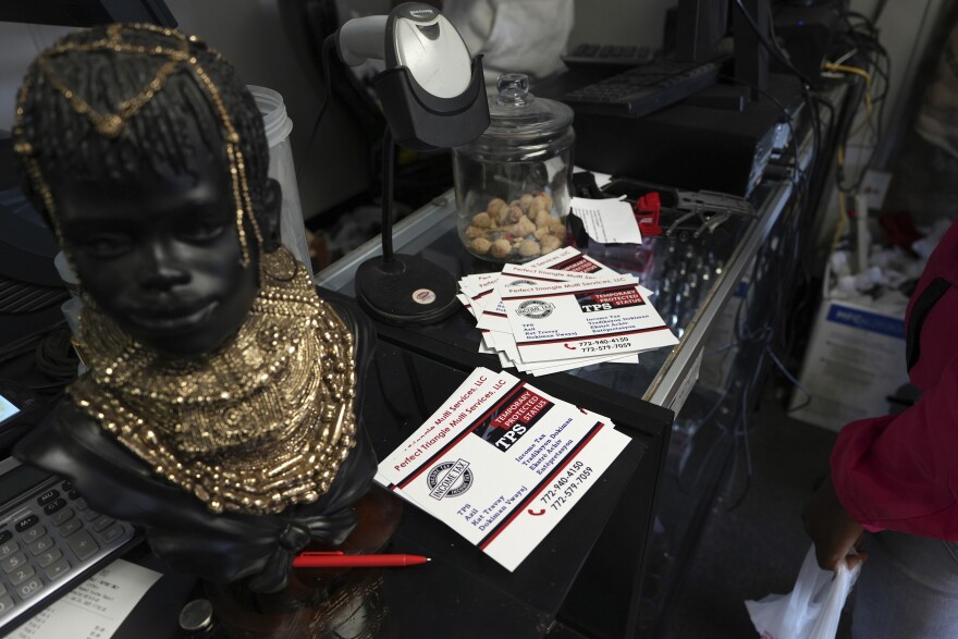 Cards with information on the Temporary Protected Status, which allows thousands of Haitian immigrants to reside legally in the United States, sit on display at Milokan Botanica, a religious supply shop that sells Haitian spiritual and natural healing products, in Springfield, Ohio, January 25, 2025. 