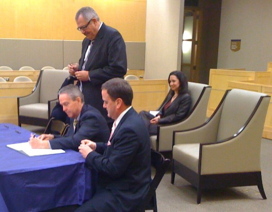 A resolution is signed creating the John Rogers Endowed Chair for the College of Law.