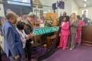 Local government officials joined the honorees in unveiling the new street sign.