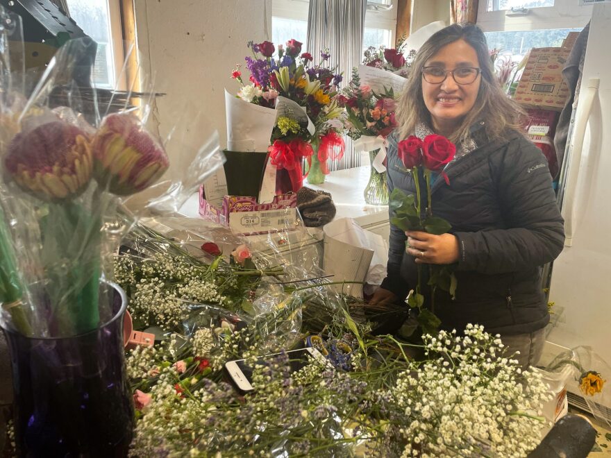 Belma Llorente surrounded by flowers as she prepares orders in time for Valentine’s Day, Feb. 13, 2023 (Brian Venua/KMXT)