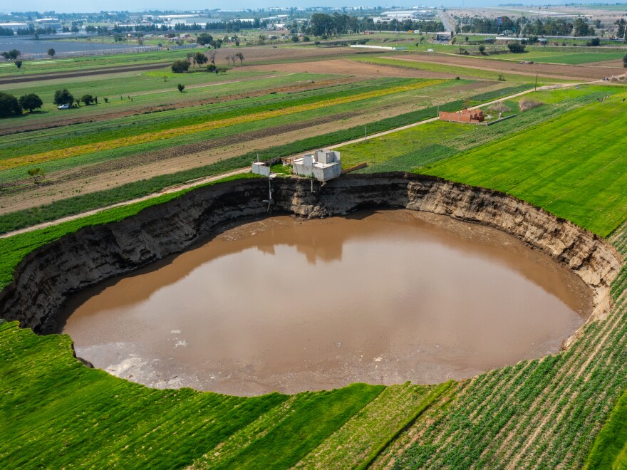 A giant sinkhole in Santa MarÃ­a Zacatepec, Mexico, is almost 500 feet across and has already swallowed the house pictured above since June 9.