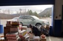 SNAP recipients line up at the New Hampshire Food Bank’s warehouse in Berlin, waiting for boxes of non-perishables and fresh produce. A New Hampshire Food Bank employee packs boxes for the people in line.