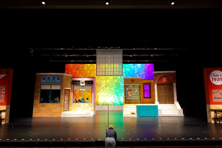 Director and choreographer Capri Williams writes down notes in front of the set for 'Grease' at the Civic Theatre located inside the Arts United Center. This week, the entire cast and crew began full rehearsals outside of the rehearsal space.