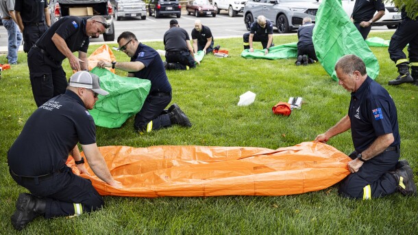 Aussie and Kiwi firefighters practice getting into fire shelters at the National Interagency Fire Center in Boise.