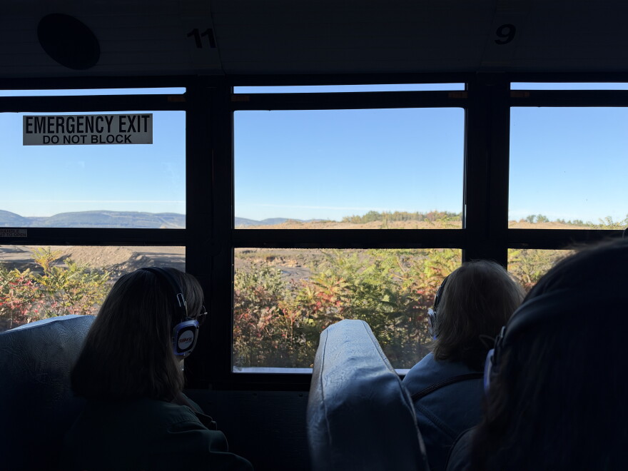 Bus riders look at land cleared for a proposed data center campus in Olyphant.