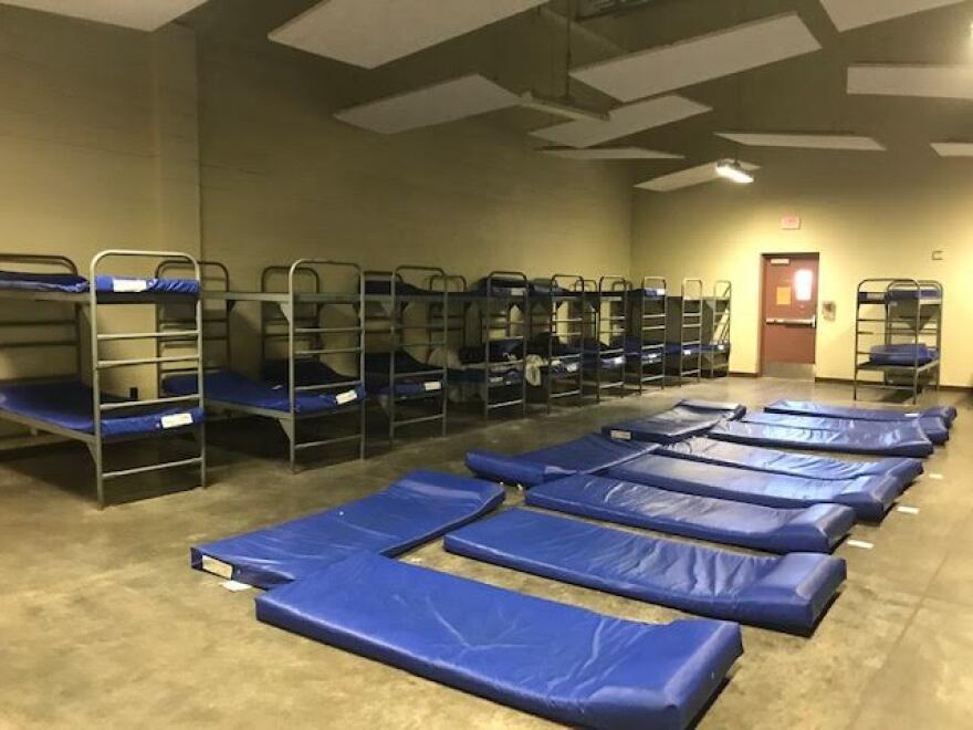 Several beds line the walls and floor at Central Arizona Shelter Services