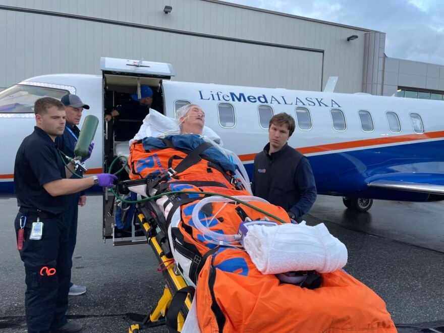 Flight medics work to keep Rick Enstrom stable while they transport him from the Providence Alaska Medical Center in Anchorage to St. Anthony’s Hospital in Lakewood. Enstrom’s battle with West Nile virus has been a long one.