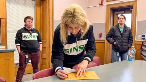 Marilyn Gleason, the director of human resources for BeLeaf Medical marijuana company, signs a sealed envelope containing 11 BeLeaf employees’ votes that the company is contesting as not being eligible to unionize on Feb. 6, 2024.