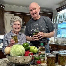 Kay Wade in her kitchen showcasing her homemade chow-chow 