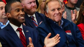 Gubernatorial candidate Rep. John James, R-Mich, left, and Mike Rogers, a Michigan Republican candidate for Senate, listen as President Donald Trump speaks during a campaign rally at McMorran Place Sports and Entertainment Center, Sunday, Oct. 25, 2026, in Port Huron, Mich. (AP Photo/Julia Demaree Nikhinson)
