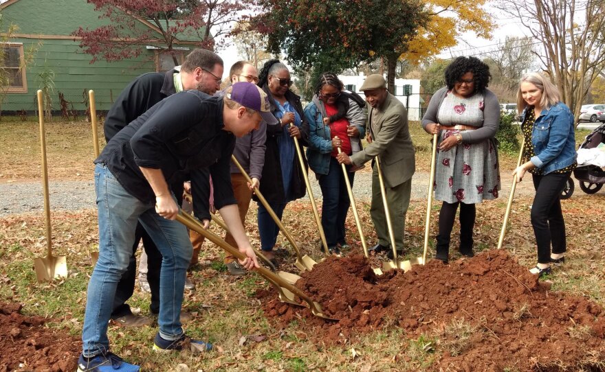 West Side Community Land Trust staff and board members tossed dirt to start the project. 