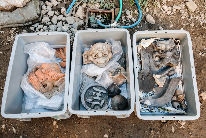 Artifacts excavated from the former site of the Jyokyo-ji temple sit in boxes.