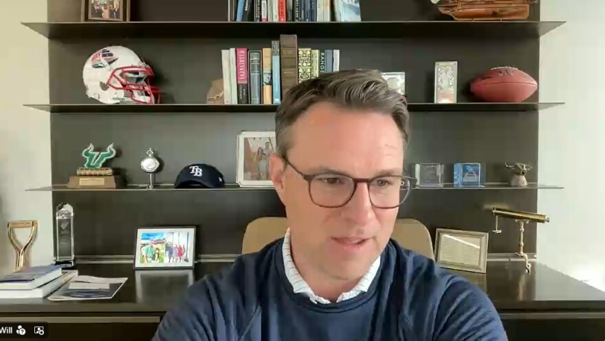 Man in sweater by bookcase