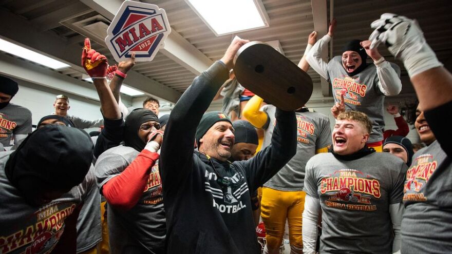 PSU Head Football Coach Brian Wright celebrates MIAA title with players