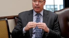 Revenue Commissioner Bruce Tangeman answers questions from the press about the governor’s 10-year budget in March. On Friday, Tangeman noted that a Moody’s Investors Services report changing Alaska’s credit rating outlook to negative used the phrase “political paralysis” twice. (Photo by Skip Gray/360 North)