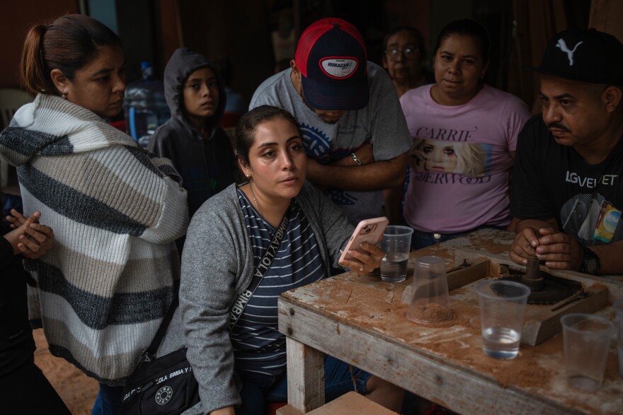 Relatives of Lt. Luis Enrique Castillo, a victim of a Mexican Navy plane crash off the Texas coast, learn about his death, at the family house in El Pantano, Veracruz state, Mexico, Tuesday, Dec. 23, 2025. (AP Photo/Felix Marquez)