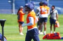 Denver Broncos linebacker Jonathon Cooper wears an orange jersey and blue helmet.