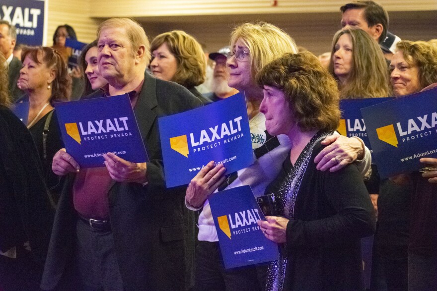 crowd holds political signs