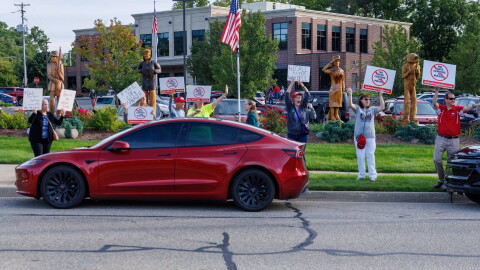 Community members protest potential data center developments in Mason, Mich., before a town hall meeting with city officials on Sept. 14, 2026.