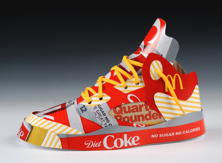 A photo of the McDonalds Diet Coke Jordan 5 sculpture by Andy Yoder.