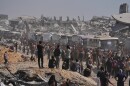 Buses carrying freed Palestinian prisoners drive past destroyed buildings in the Gaza Strip after their release from Israeli jails under a ceasefire agreement between Hamas and Israel, in Khan Younis, southern Gaza Strip, Monday, Oct. 13, 2025.