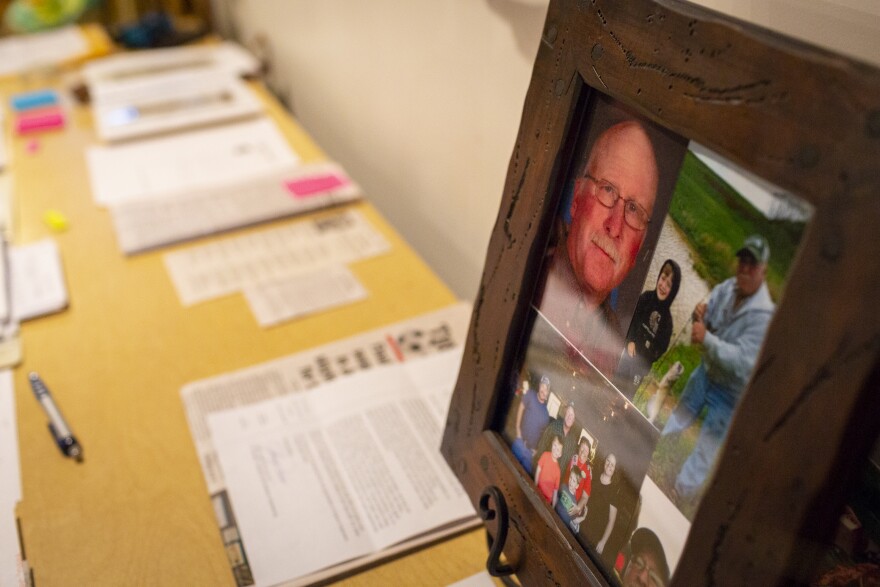 Lisa Hobbs's table is covered with documents and articles relating to her husband and his death. Gene Hobbs was run over by a coworker on a construction site in December 2016.