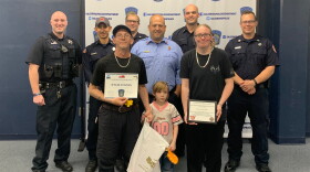 Kylee Stivers, 6, is pictured with her parents, Gary and Sylvia Stivers, and Galesburg police and firefighters.