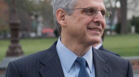 gray haired man in suit and tie
