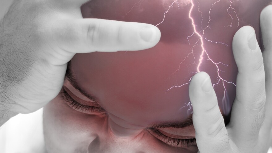 person holding their head