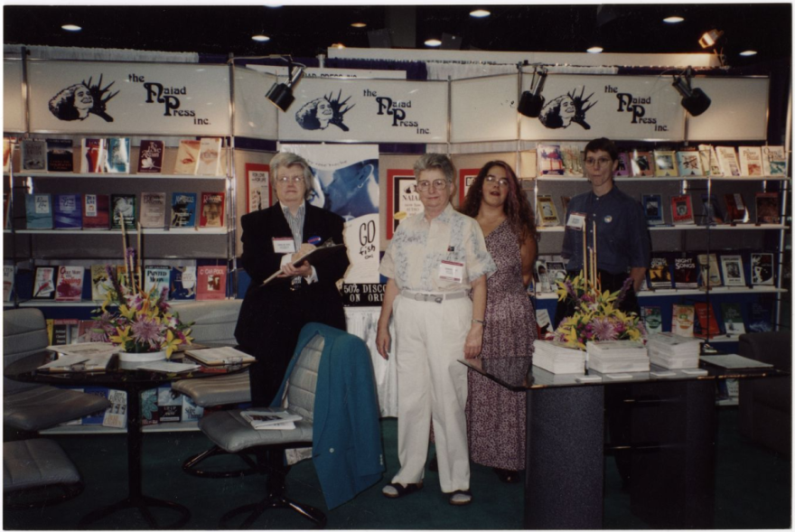Donna McBride (left) and Barbara Grier (center) with two others in the Naiad Press booth at the American Booksellers Association meeting