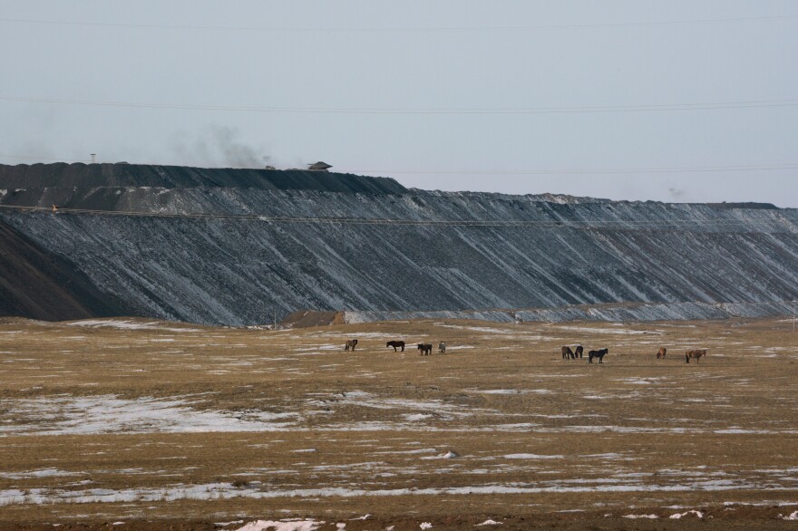 Horses graze in pastureland just outside one of Tavan Tolgoi's open-pit mines, where coal is being extracted for export.