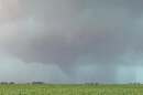A tornado forms over a field. 