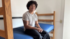 College student on his bed in his dorm room