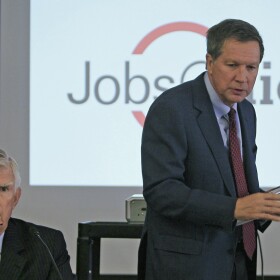 FILE – In this Feb. 1, 2012, file photo, Ohio Gov. John Kasich arrives at a JobsOhio board meeting in Cincinnati. Kasich and the Republican governor's chief of staff Beth Hansen, spokesman Jim Lynch and security detail depart for Germany and England on Thursday, Feb. 16, 2017, for business and policy discussions with corporate and world leaders, planned by the governor's privatized job-creation office JobsOhio. (AP Photo/Al Behrman, File)