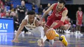 New Mexico guard Jaelen House (10) and San Jose State guard Myron Amey Jr. try to get possession of the ball during the second half of an NCAA college basketball game Wednesday, Jan. 24, 2024, in San Jose, Calif. (AP Photo/Tony Avelar)