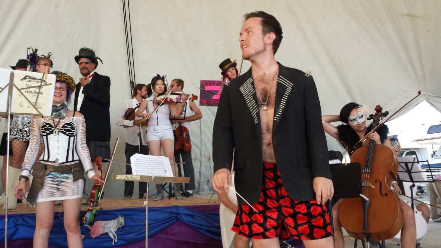 Dr. FireTuba (Eric Yttri) conducted the first-ever string orchestra at Burning Man in 2014.