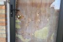 Holes left by bullets in the front door at the home of Indianapolis City-County Councilor Ron Gibson Monday, April 6, 2026.