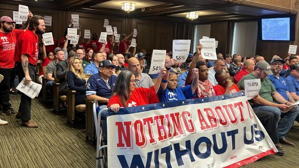 Members of Stand Up KC and the Missouri Workers Center pack Kansas City Council chambers on Thursday to oppose the passage of a financing deal for a new Royals stadium. Sitting behind and around them are members of the building trades unions, who support the deal.