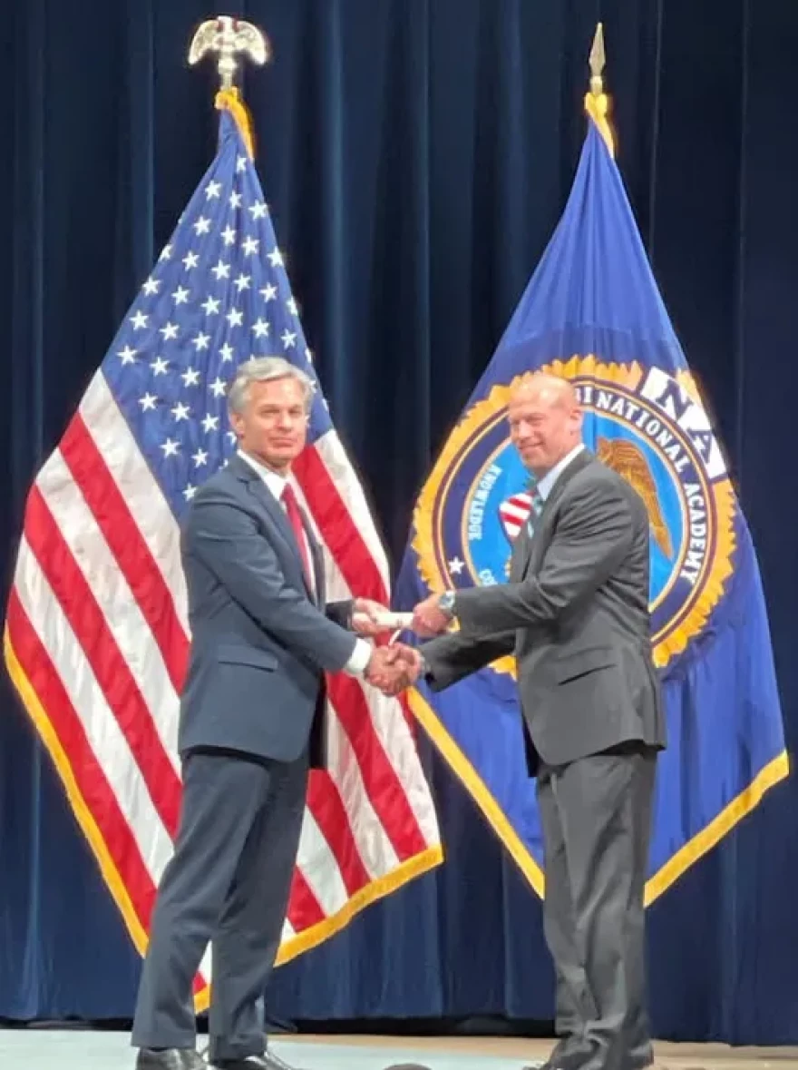 On June 9, 2023, the city posted a photo of Mark Pingsterhaus shaking hands with then FBI Director Christopher Wray, heralding Pingsterhaus completing the FBI Academy. Pingsterhaus later was suspended amid an FBI investigation.