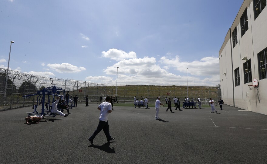 In this photo taken June 21, 2017, a razor-wire fence is shown around a recreation yard at the Northwest Detention Center in Tacoma. The company that owns and operates the center is planning another expansion.