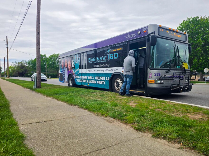 Riders board a Saginaw Transit Authority Regional Services bus at a stop in Saginaw, Michigan, on Friday, May 15, 2026.