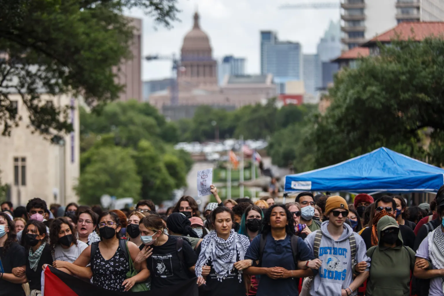 Student protesters link arms during a demonstration on the South Mall lawn at the UT-Austin campus on April 24, 2024.