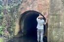 Listener and Carolina Curious question submitter Adam Leonard looks into a tunnel entrance near Old Salem.