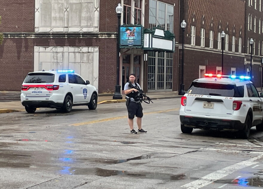 An unidentified officer is armed with an automatic weapon outside Signature School after an apparent false report of someone with a gun inside the downtown school