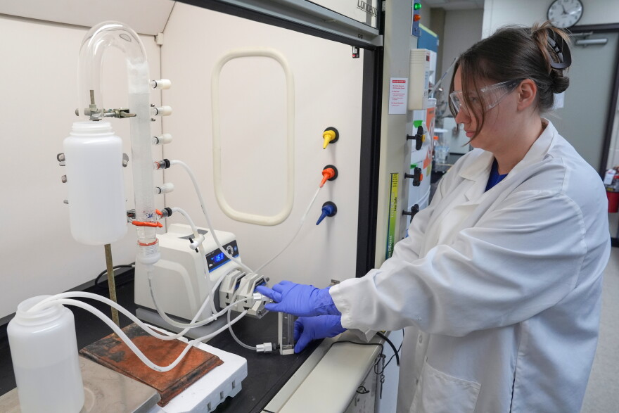 FILE - Stephanie Stoll starts a pump as part of an experiment studying the removal of PFAS from water samples, April 10, 2024, at a U.S. Environmental Protection Agency lab in Cincinnati. (AP Photo/Joshua A. Bickel, File)
