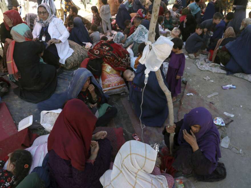 Internally displaced Afghan women from northern provinces, who fled their home due to fighting between the Taliban and Afghan security personnel, receive medical care in a public park in Kabul, Afghanistan, Tuesday, Aug. 10, 2021. (AP Photo/Rahmat Gul)